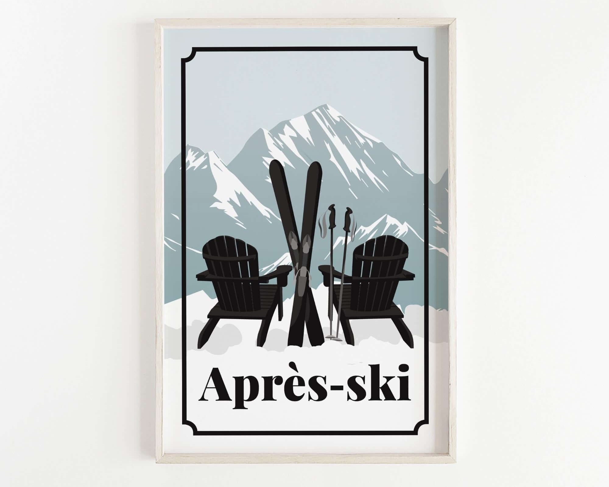 A framed print featuring a pair of black Adirondack chairs with skis crossed in front of them, set against a snowy mountain landscape.