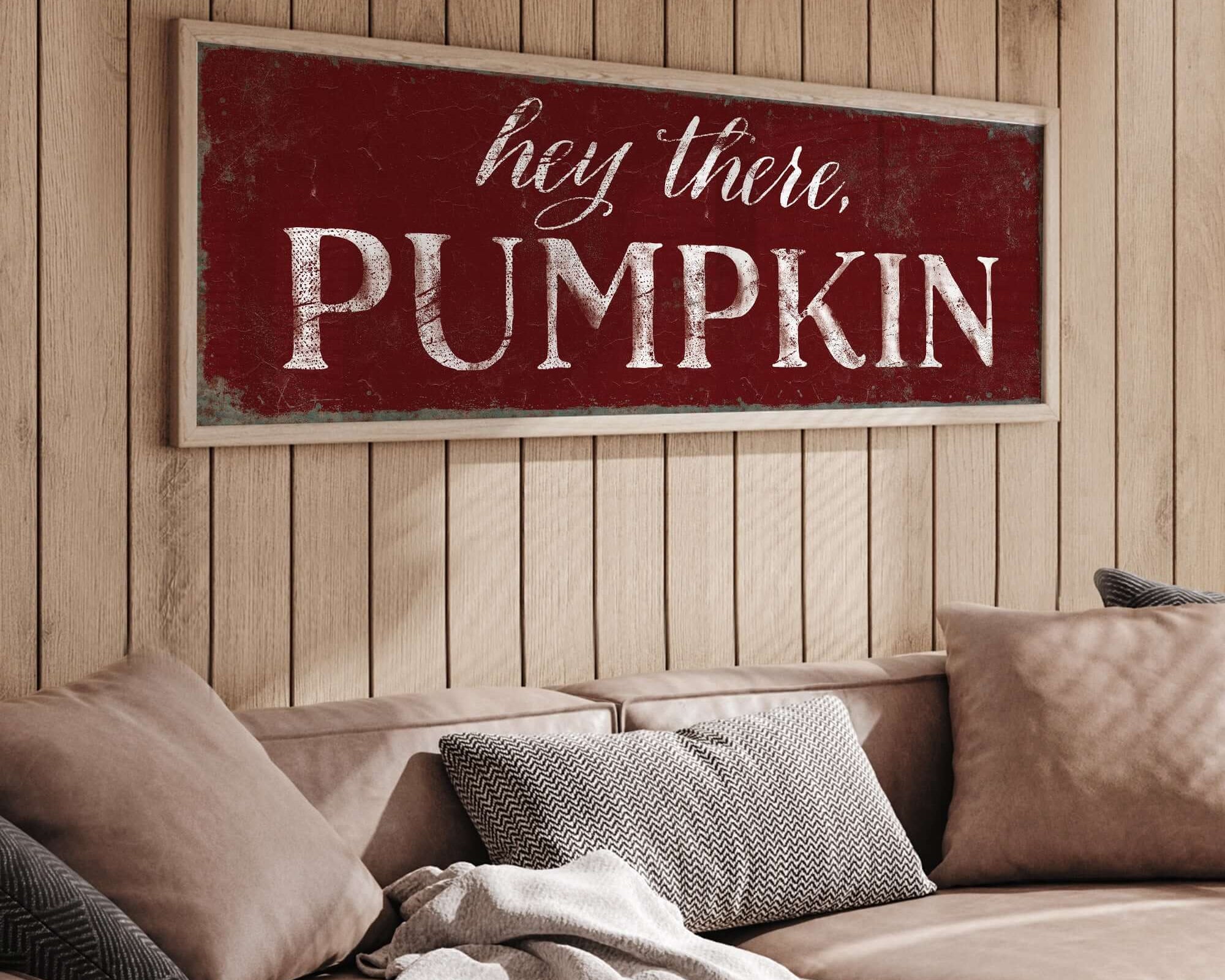 a living room with a couch and a wooden sign on the wall