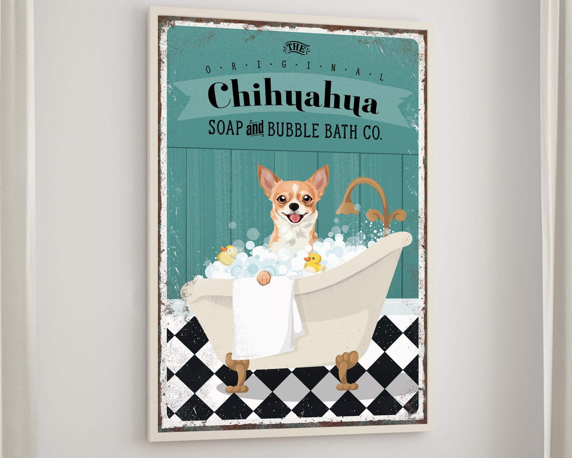 A framed poster of a Chihuahua dog sitting in a bathtub, surrounded by bubbles, with a towel and a book on a table below it.
