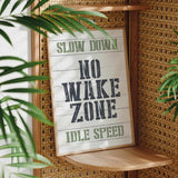 a sign that reads slow down no wake zone idle speed