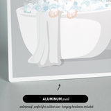 a person relaxing in a bathtub filled with bubbles, with a towel draped over the side.