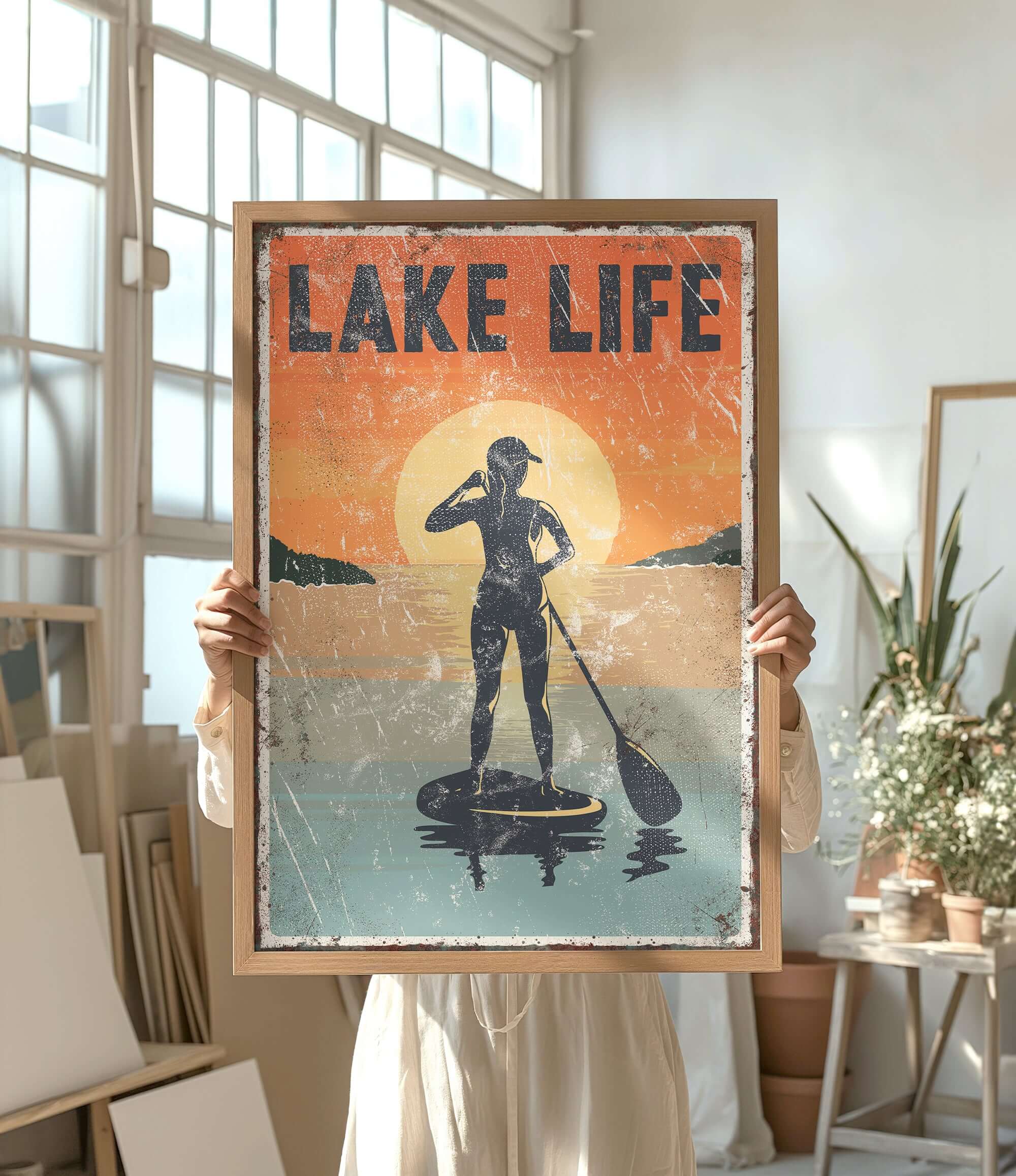 a woman holding up a poster of a man on a surfboard