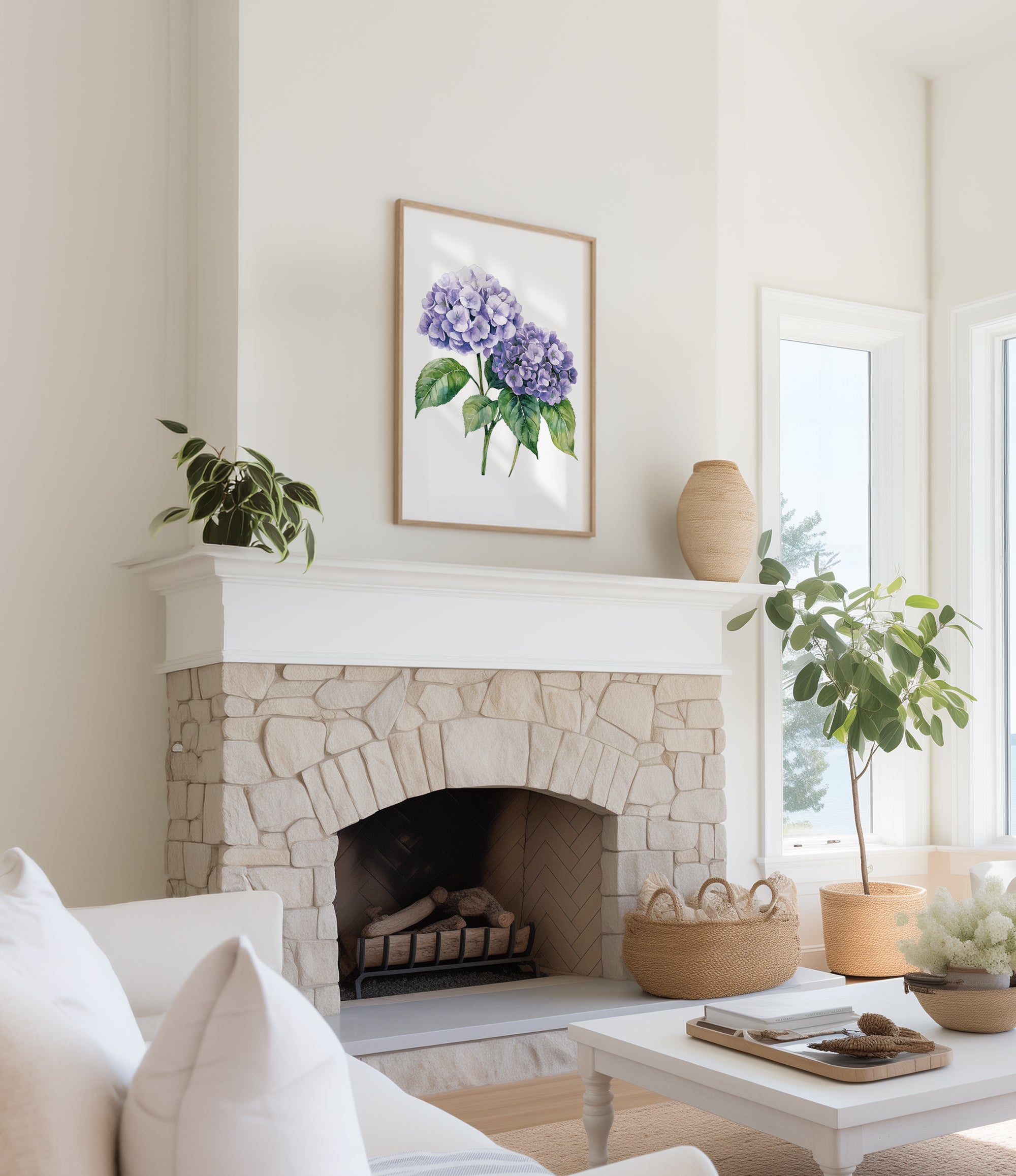 a cozy living room with a stone fireplace, a framed watercolor painting of purple hydrangeas hanging above it, and a white sofa. The room is decorated with potted plants and a woven basket, creating a warm and inviting atmosphere.