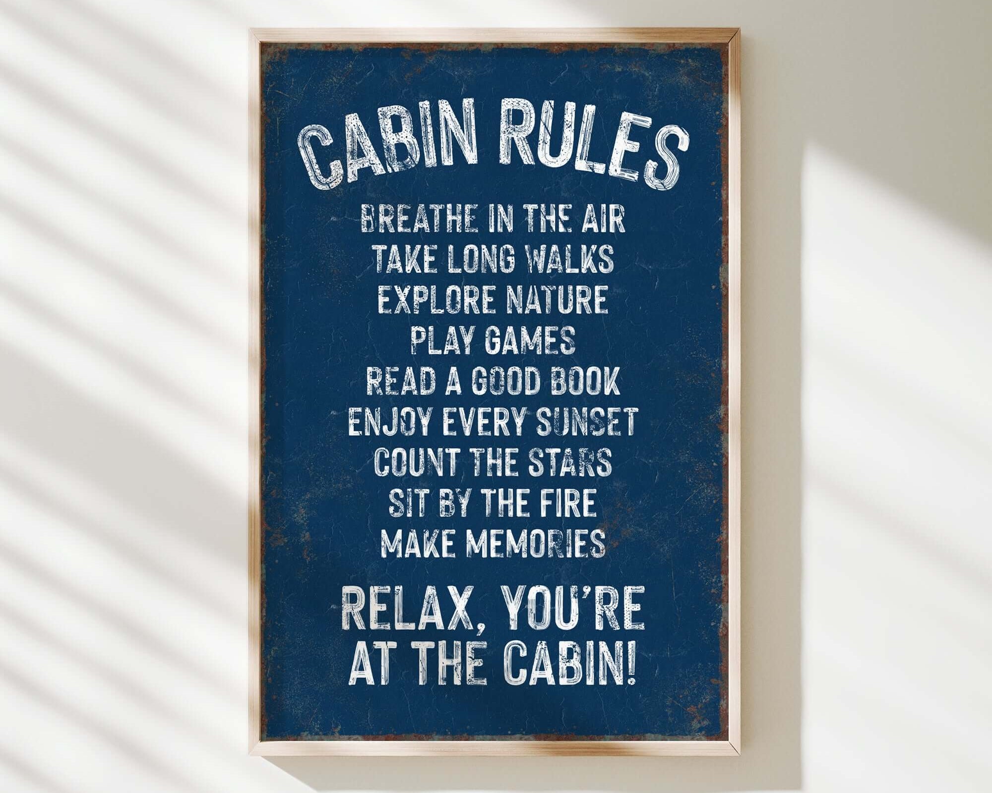 a blue sign that says cabin rules hanging on a wall