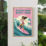 A framed poster with a woman surfing on a wave, surrounded by tropical plants.