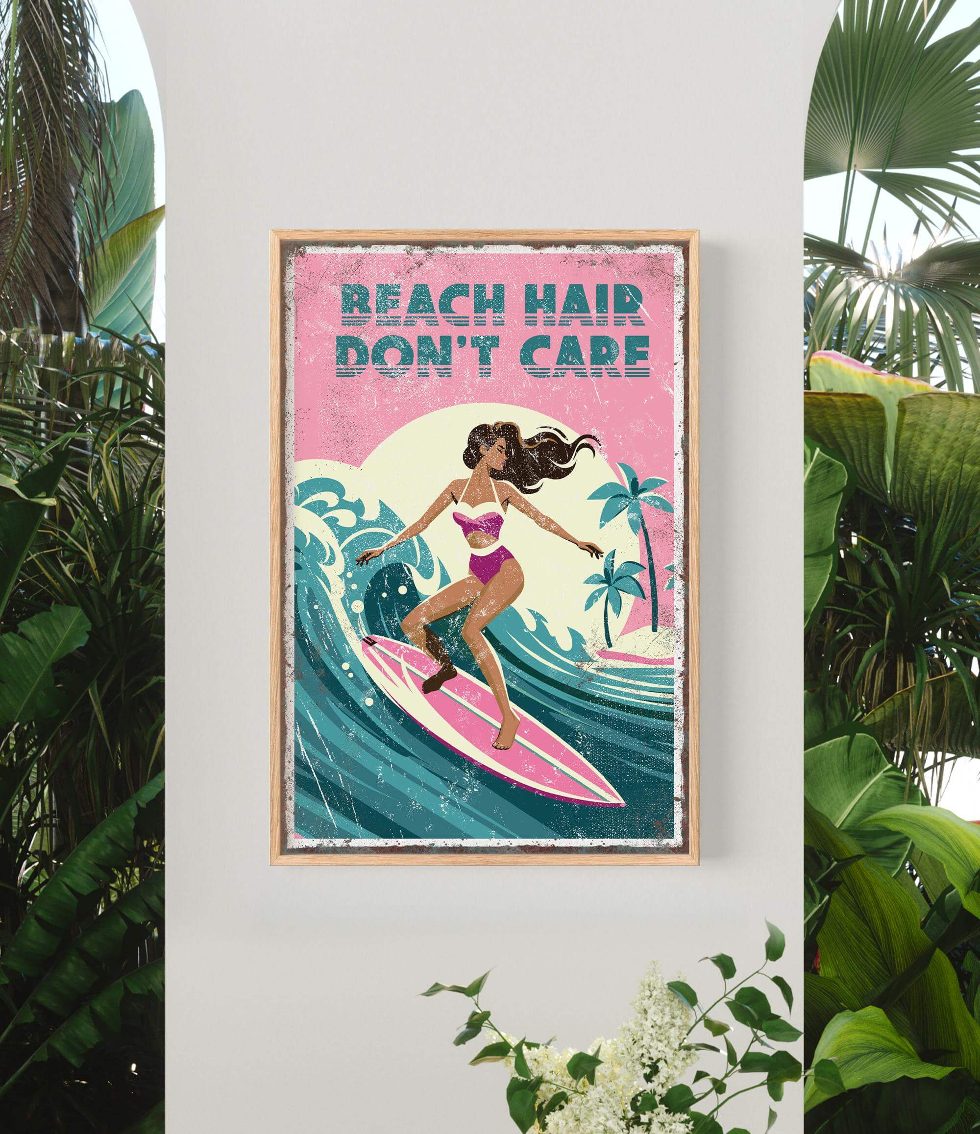 A framed poster with a woman surfing on a wave, surrounded by tropical plants.