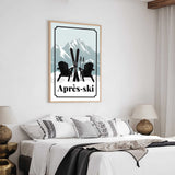a bedroom with a bed, two lamps, and a framed poster of a mountain landscape with ski equipment.