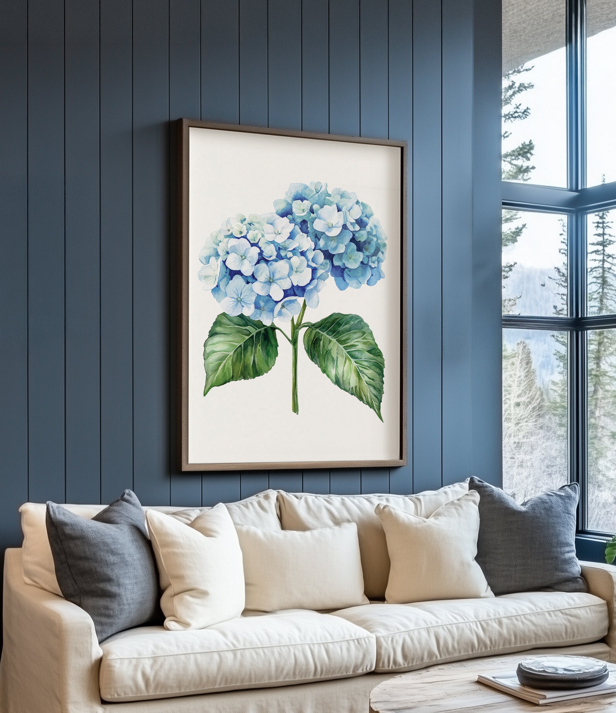 a large framed print of a blue hydrangea flower hanging on a blue wall above a white couch with gray and beige throw pillows.