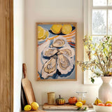 a kitchen counter with a framed painting of oysters, a vase of flowers, and various fruits and vegetables.