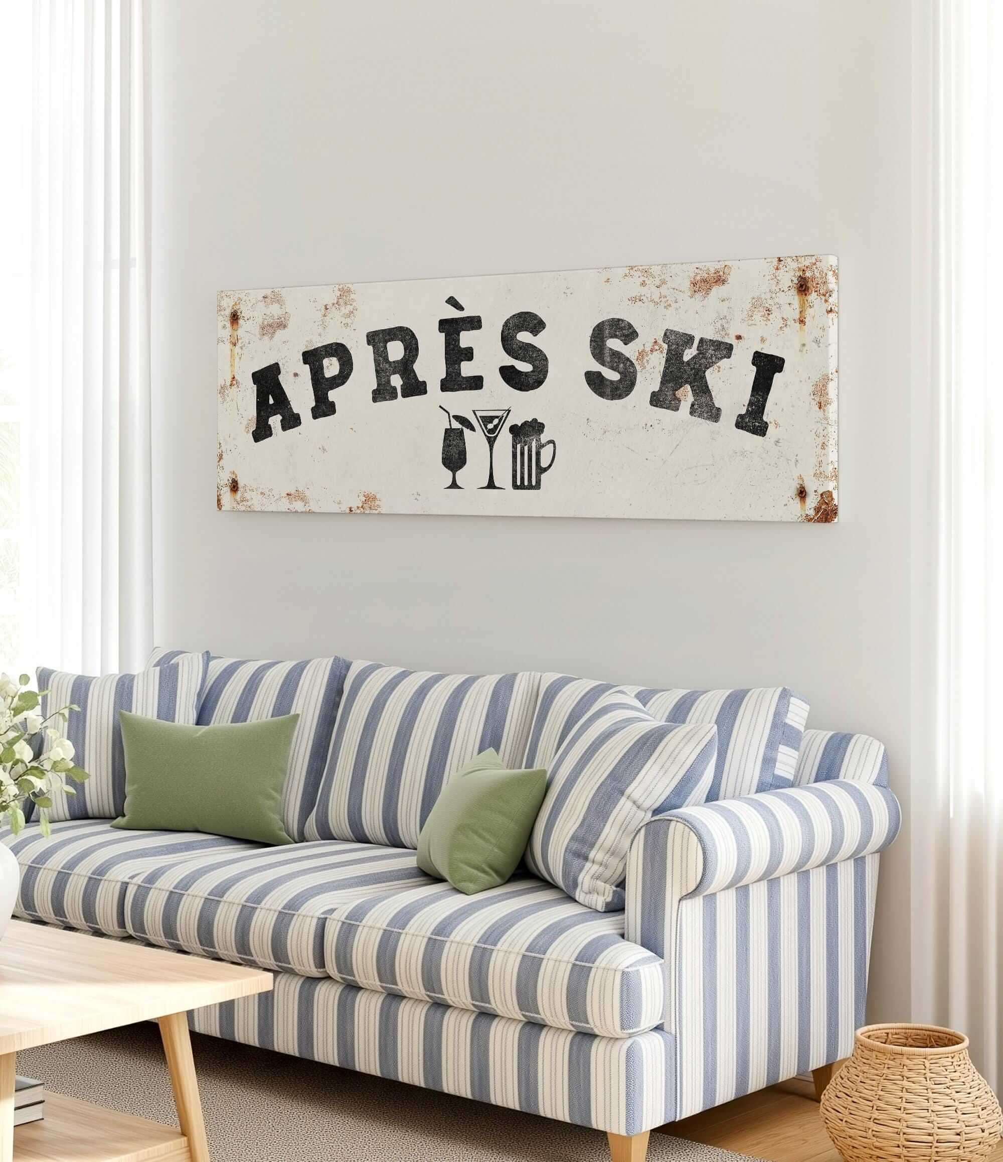 a living room with a striped couch, a coffee table, and a large sign that says "APRÈS SKI" hanging on the wall.