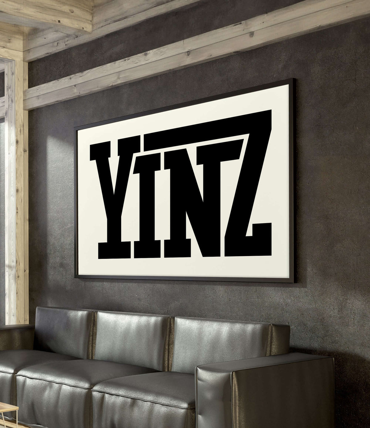 A modern living room featuring the Yinz Sign Print, Off White as home decor, with a large framed print displaying "YINZ" in bold black letters on the wall.