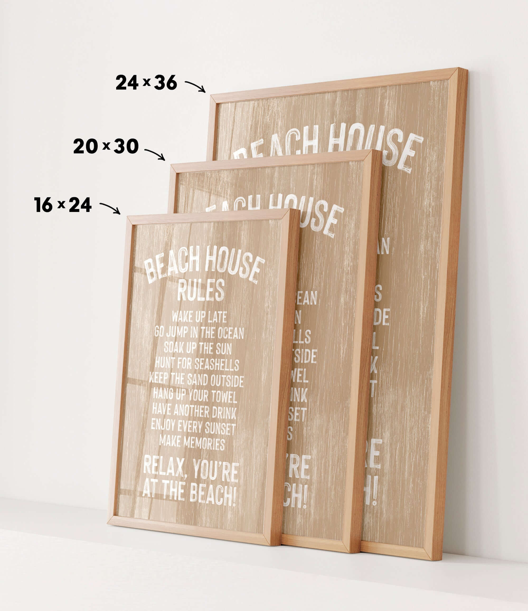 three framed beach house rules posters, each with a different size and orientation, displayed on a white wall.