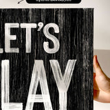 a hand holding up a sign that says let's play