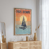 a picture of a sailboat on a wall above a dresser