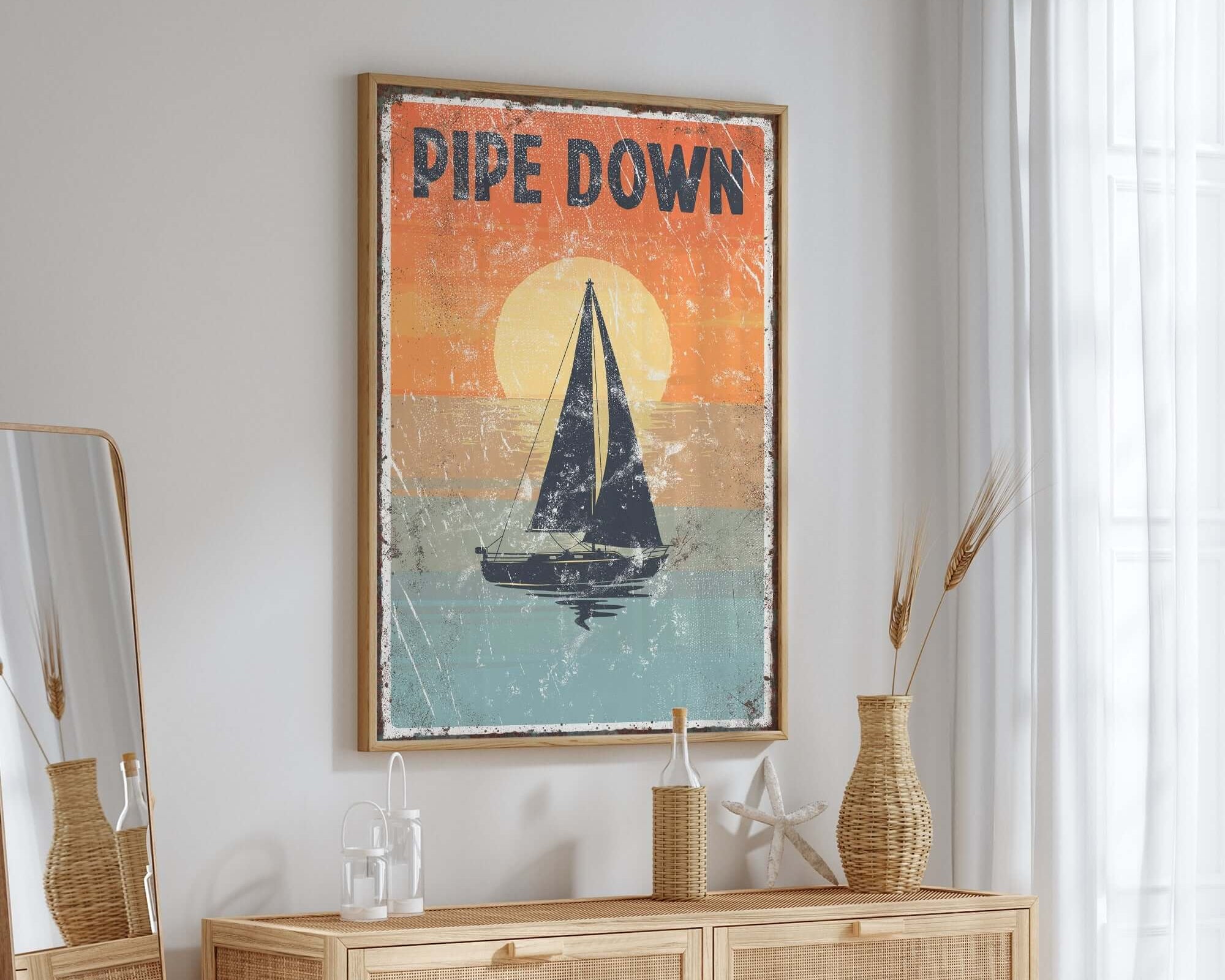 a picture of a sailboat on a wall above a dresser