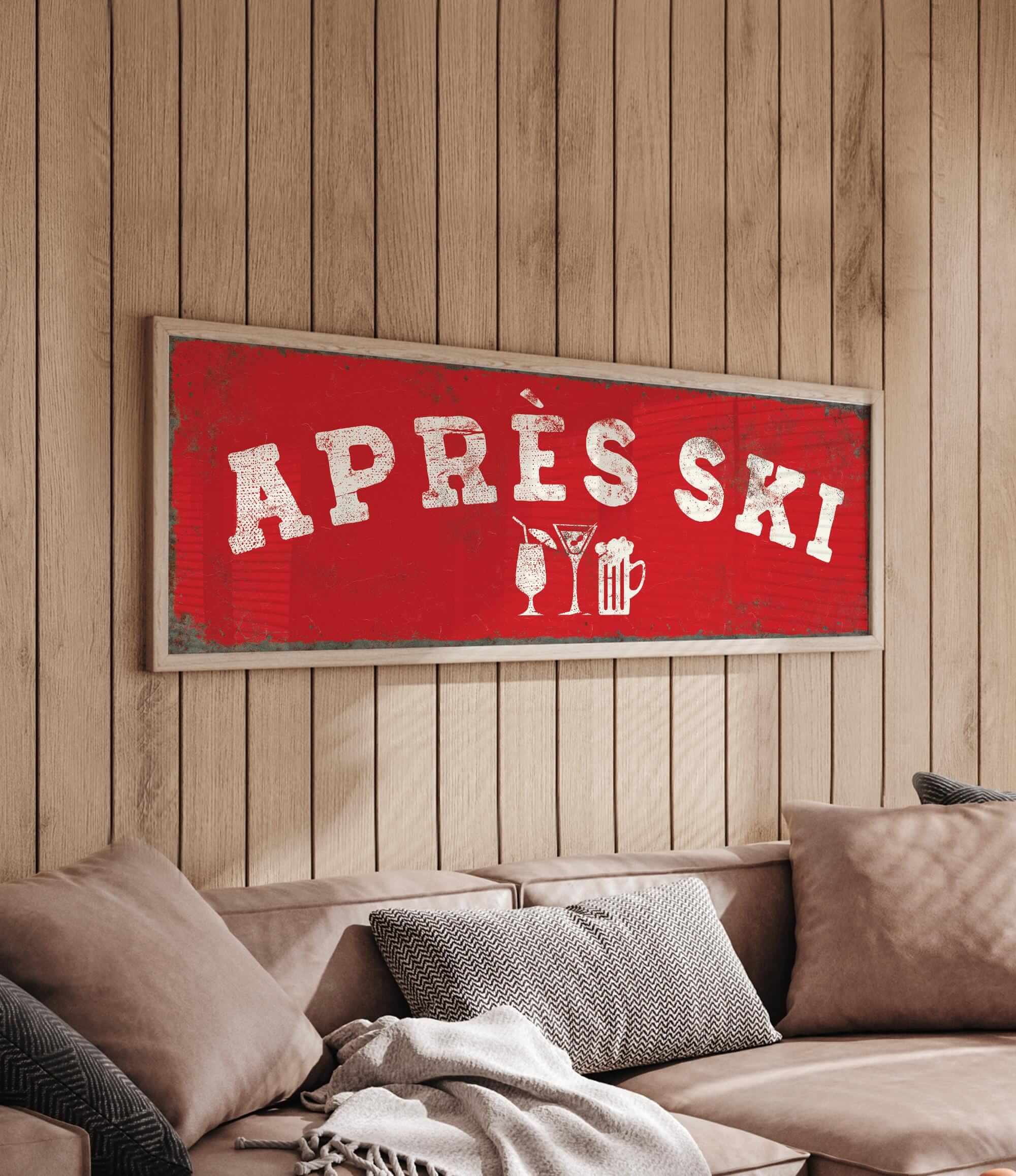 a cozy living room with a large red sign that reads "APRÈS SKI" hanging on the wall above a couch.