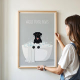 A framed poster with a black dog sitting in a bathtub filled with bubbles, accompanied by the text "WASH YOUR PAWS".