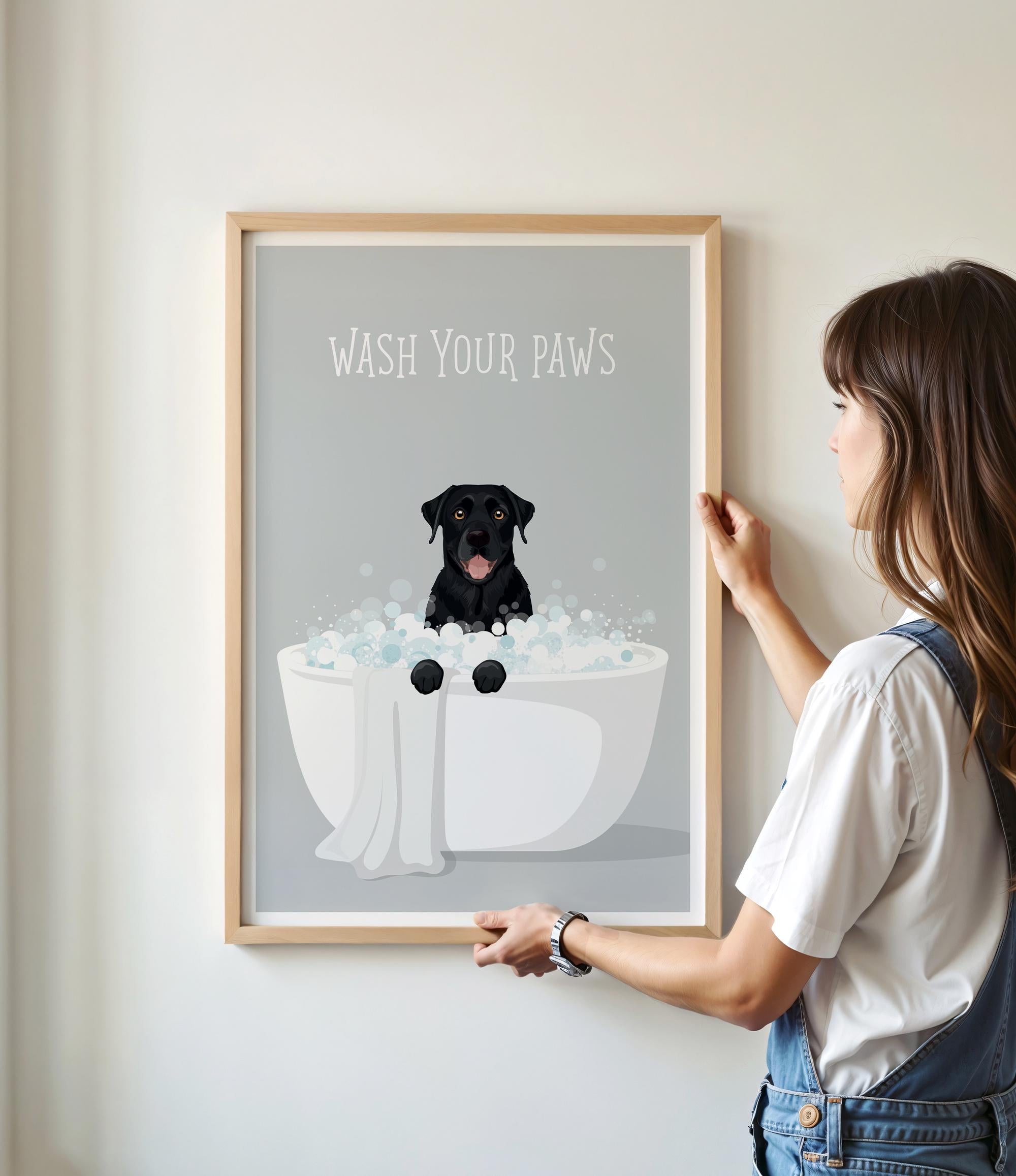 A framed poster with a black dog sitting in a bathtub filled with bubbles, accompanied by the text "WASH YOUR PAWS".