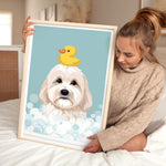 A woman is sitting on a bed holding a framed picture of a dog with a yellow rubber duck on its head.