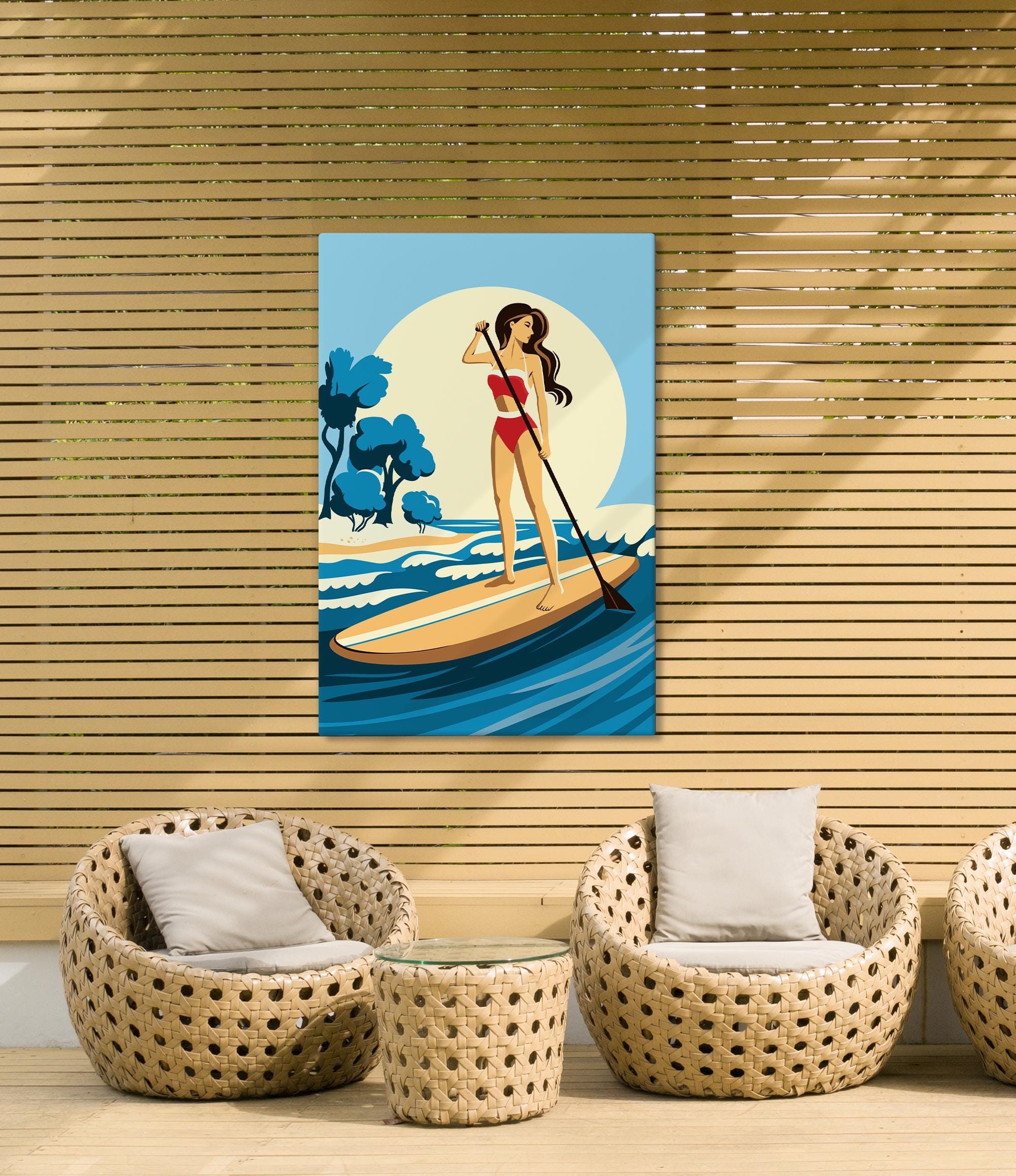 a woman paddleboarding on a beach, with a wicker chair and a wicker table in the foreground.