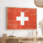 a red and white cross painted on a wall above a table