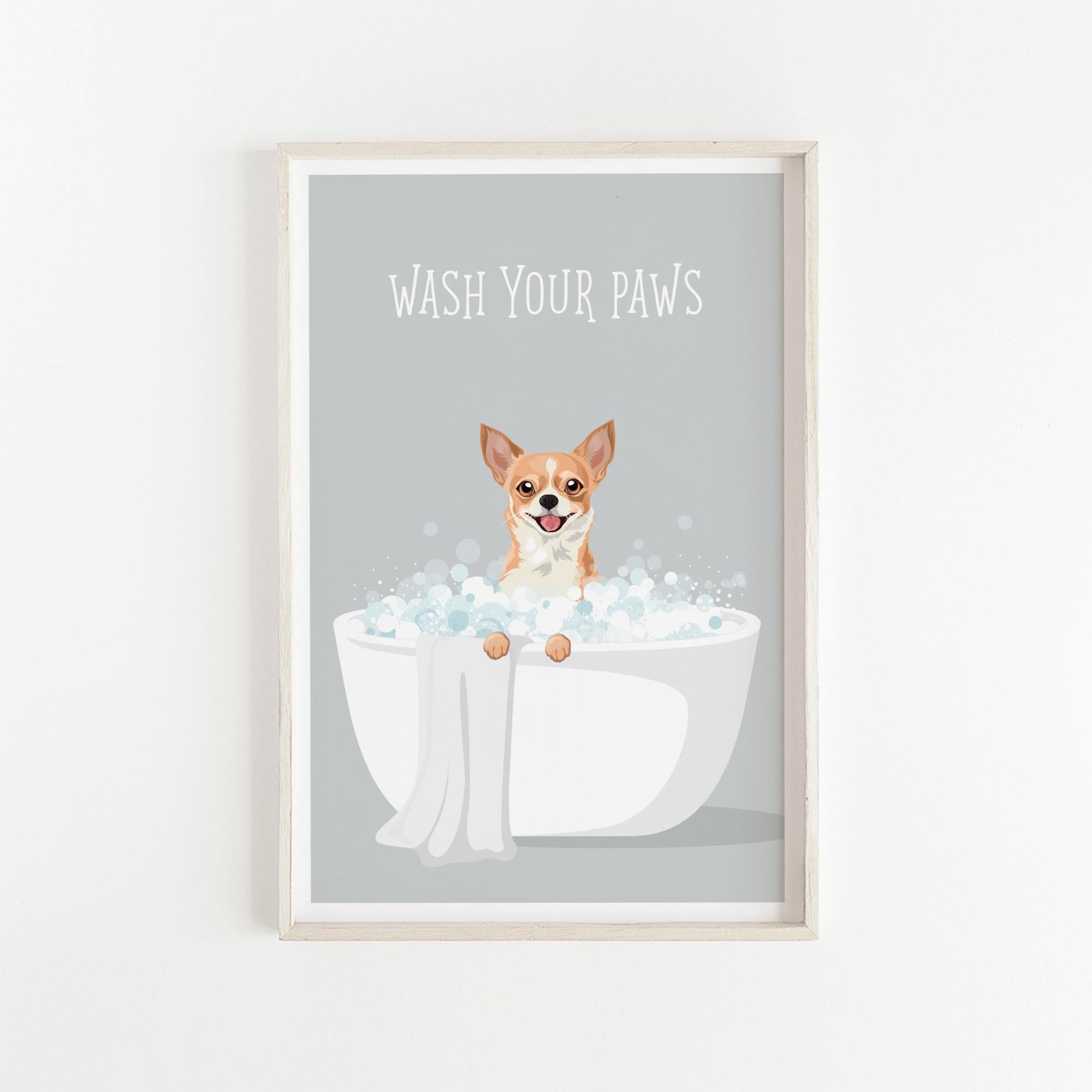 A framed poster with a cartoon image of a dog sitting in a bathtub filled with bubbles, with the text "WASH YOUR PAWS" written above it.