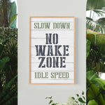 a sign that says slow down, no wake zone, idle speed