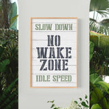 a sign that says slow down, no wake zone, idle speed