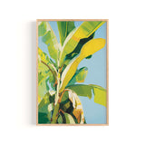 The image is a vibrant painting of a banana tree with large, yellow leaves against a blue background.
