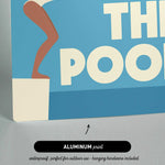 The image is an aluminum print featuring a swimming pool with a woman in a white swimsuit.