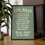 a picture of a pool rules sign next to a potted plant
