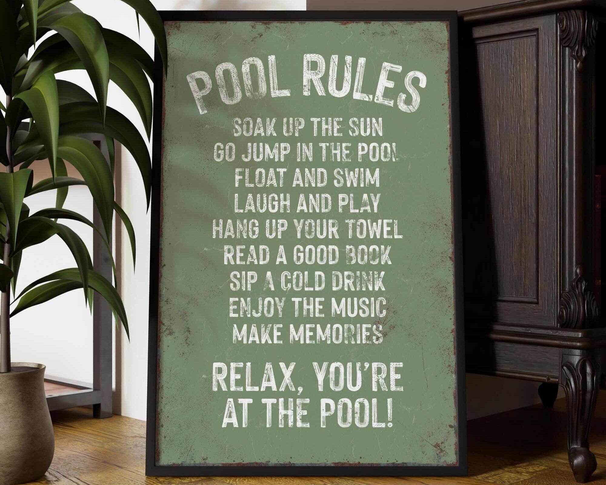 a picture of a pool rules sign next to a potted plant