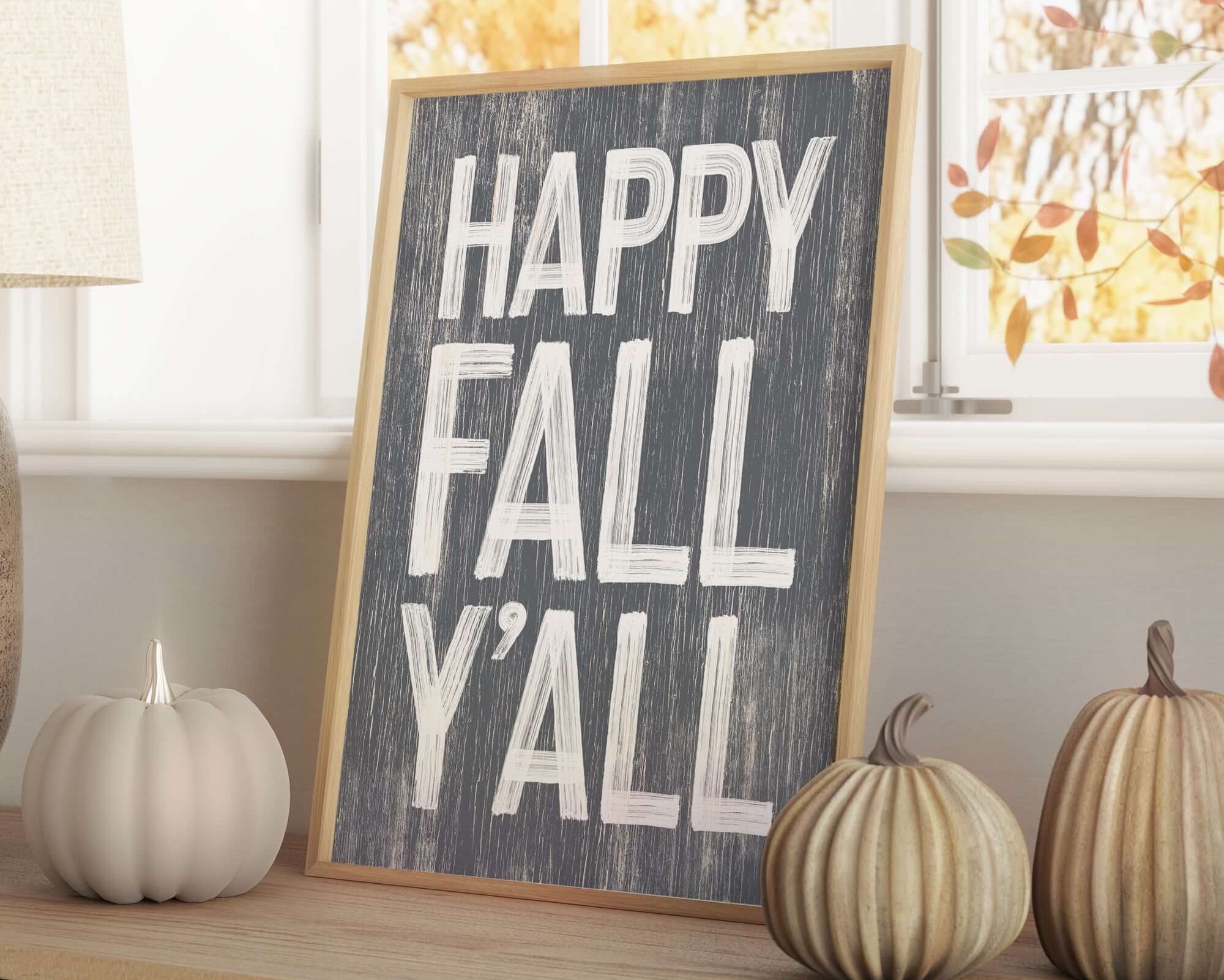 a sign that says happy fall y'all next to some pumpkins