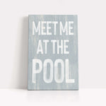 a wooden sign that says meet me at the pool