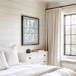 a bedroom with a bed, dresser and window