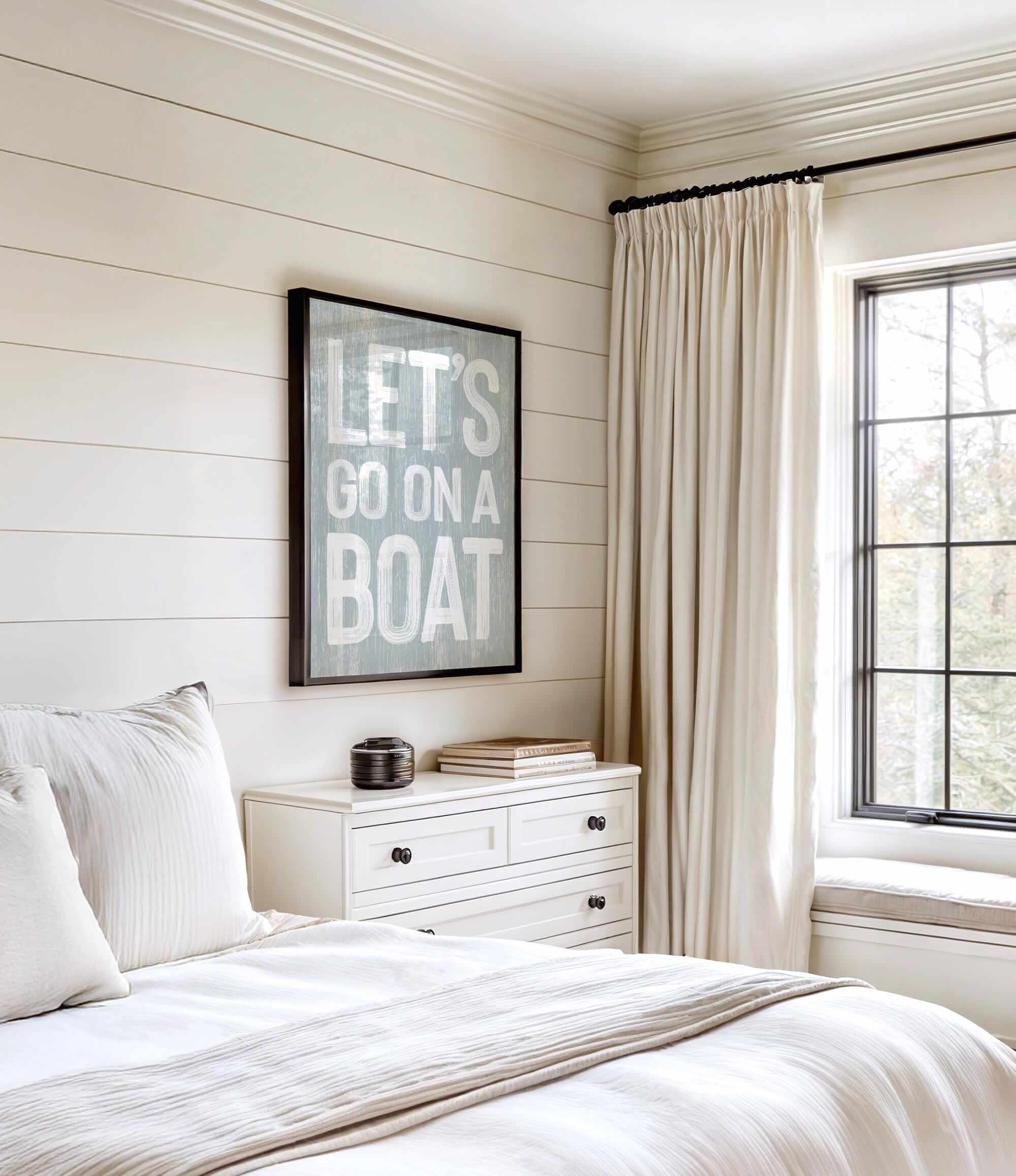 a bedroom with a bed, dresser and window