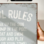 a hand holding a sign that says oil rules