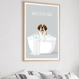 a framed poster with a cartoon illustration of a dog sitting in a bathtub filled with bubbles, with the text "WASH YOUR PAWS" written above it.