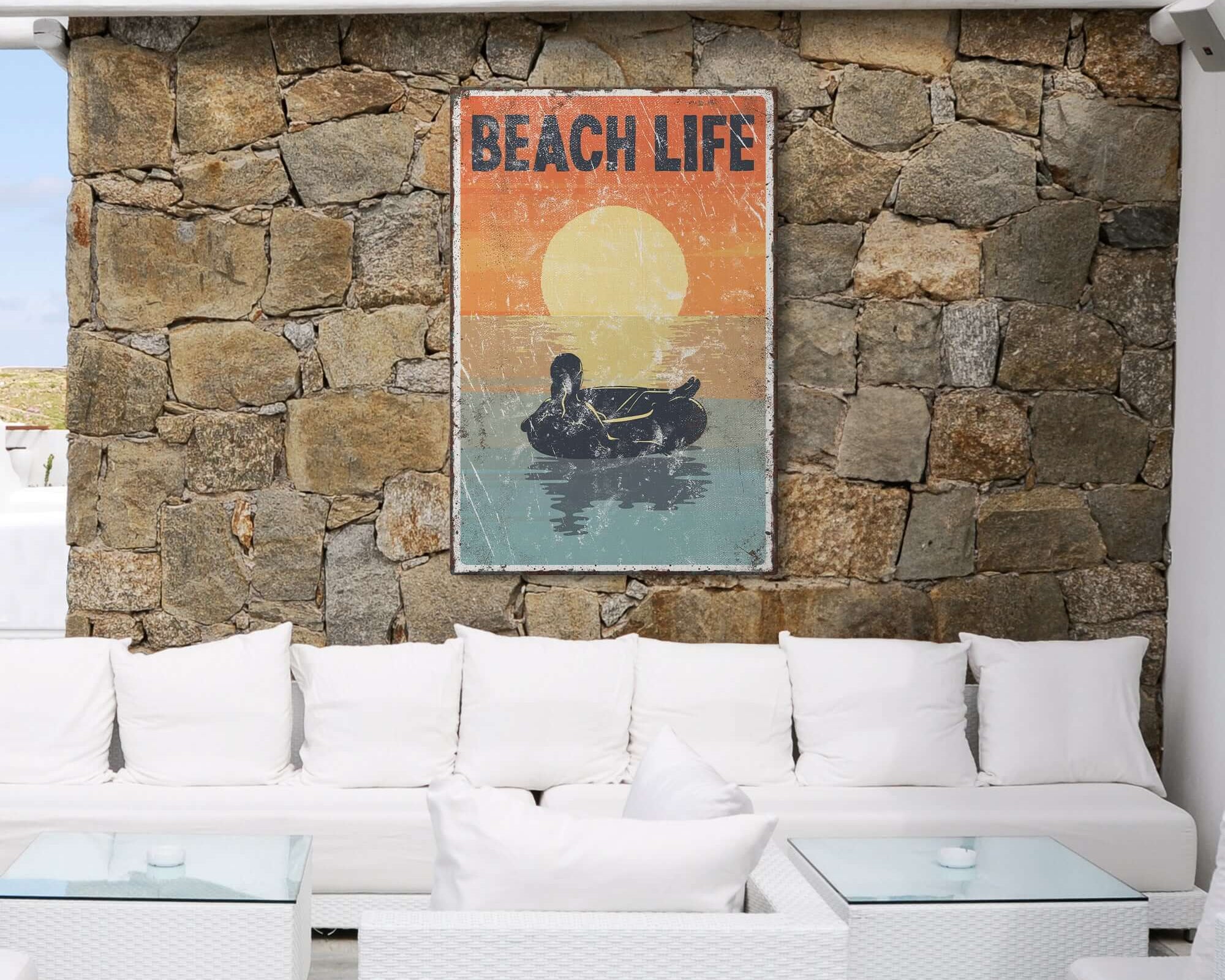 a white couch sitting under a painting on a stone wall
