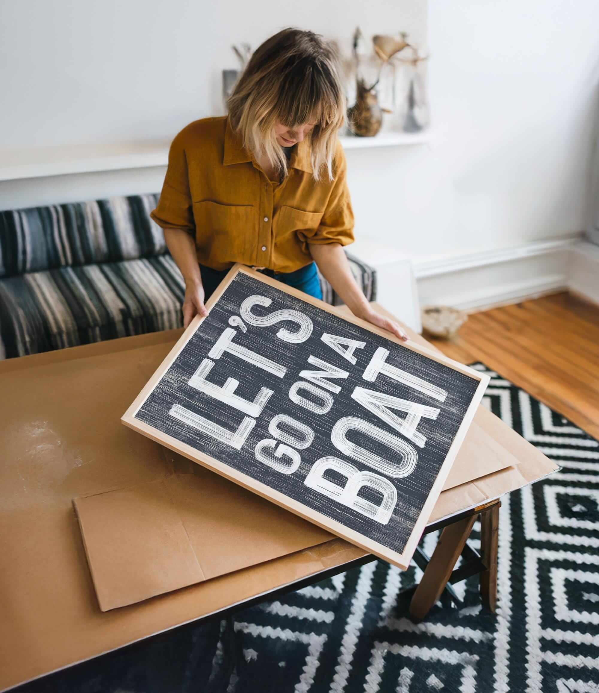 a woman holding a sign on top of a table