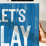 a hand holding a sign that says let&#39;s play