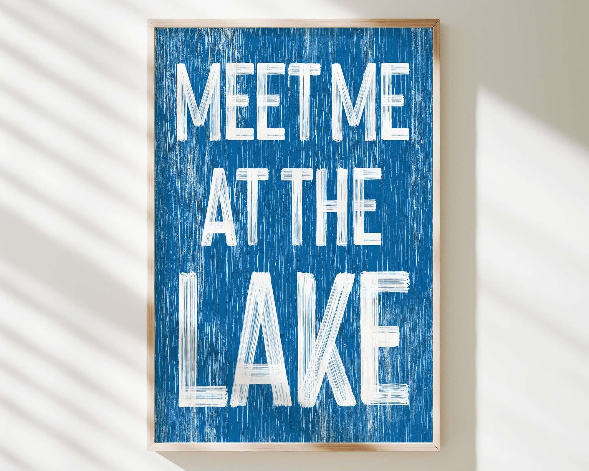 a blue sign that says meet me at the lake