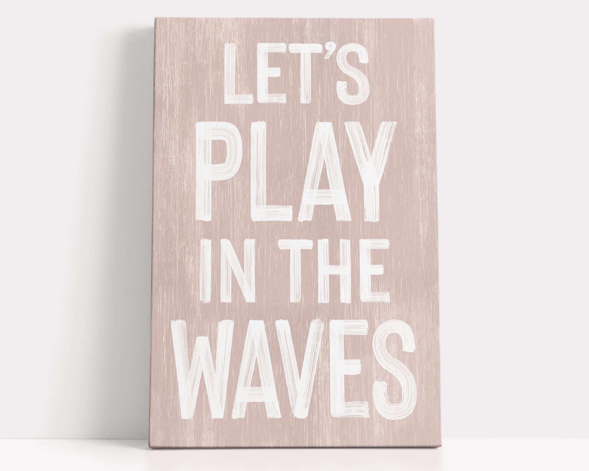 a wooden sign that says let's play in the waves