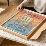 A person is holding a framed sign with the text "BEACH HOUSE RULES" on it, which appears to be a beach-themed decoration or sign.