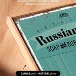 a close-up of a canvas print with the text "Russian SOAP and BUB" printed on it, along with some text indicating that the artwork wraps around the sides of the canvas and includes hanging hardware.