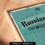 a close-up of a canvas print with the text "Russian SOAP and BUB" printed on it, along with some text indicating that the artwork wraps around the sides of the canvas and includes hanging hardware.