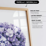 a framed print of a bouquet of purple flowers, with a natural frame.