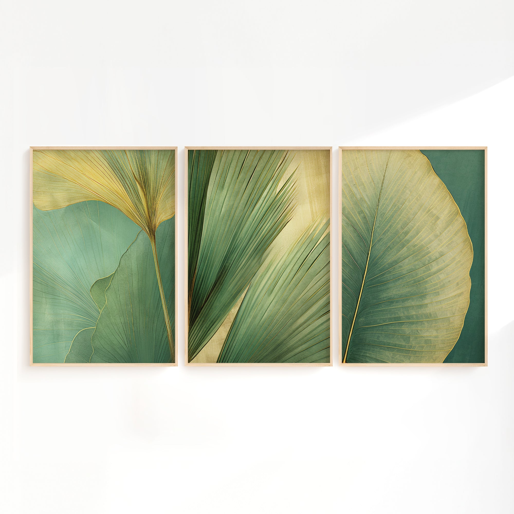 three framed artworks depicting various green leaf patterns, arranged in a row on a white wall.