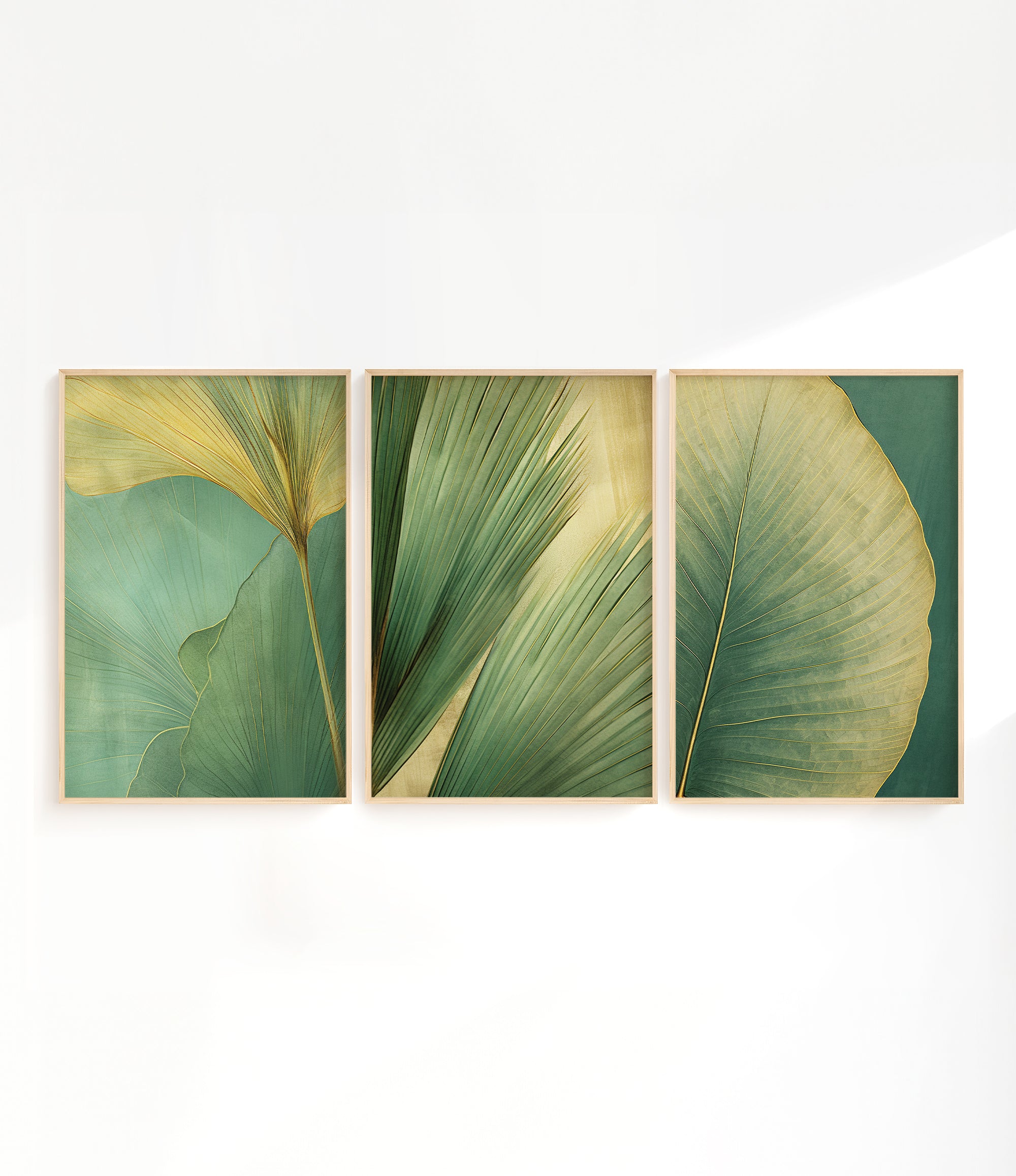 three framed artworks depicting various green leaf patterns, arranged in a row on a white wall.