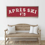 a wooden bench with two pillows, and above it is a red sign with the text "APRÈS SKI" in white letters.